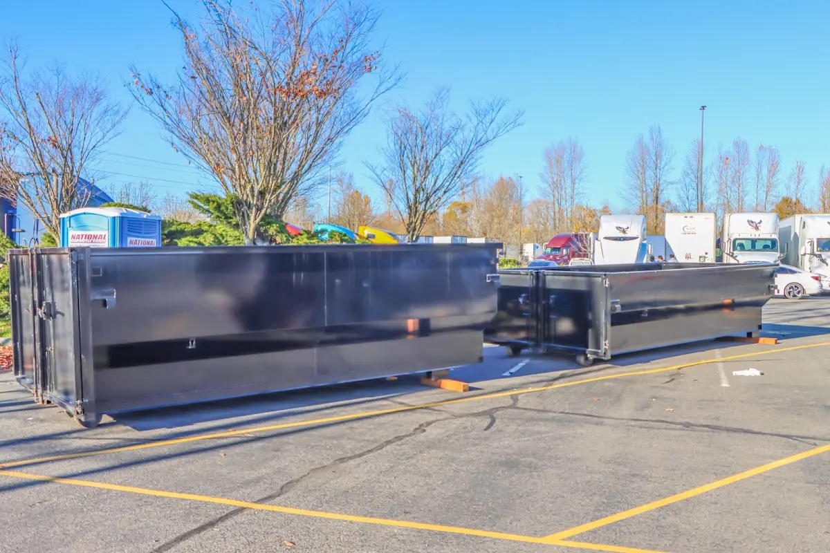 Professional dumpster rental service with roll-off container on residential driveway in Brownstown